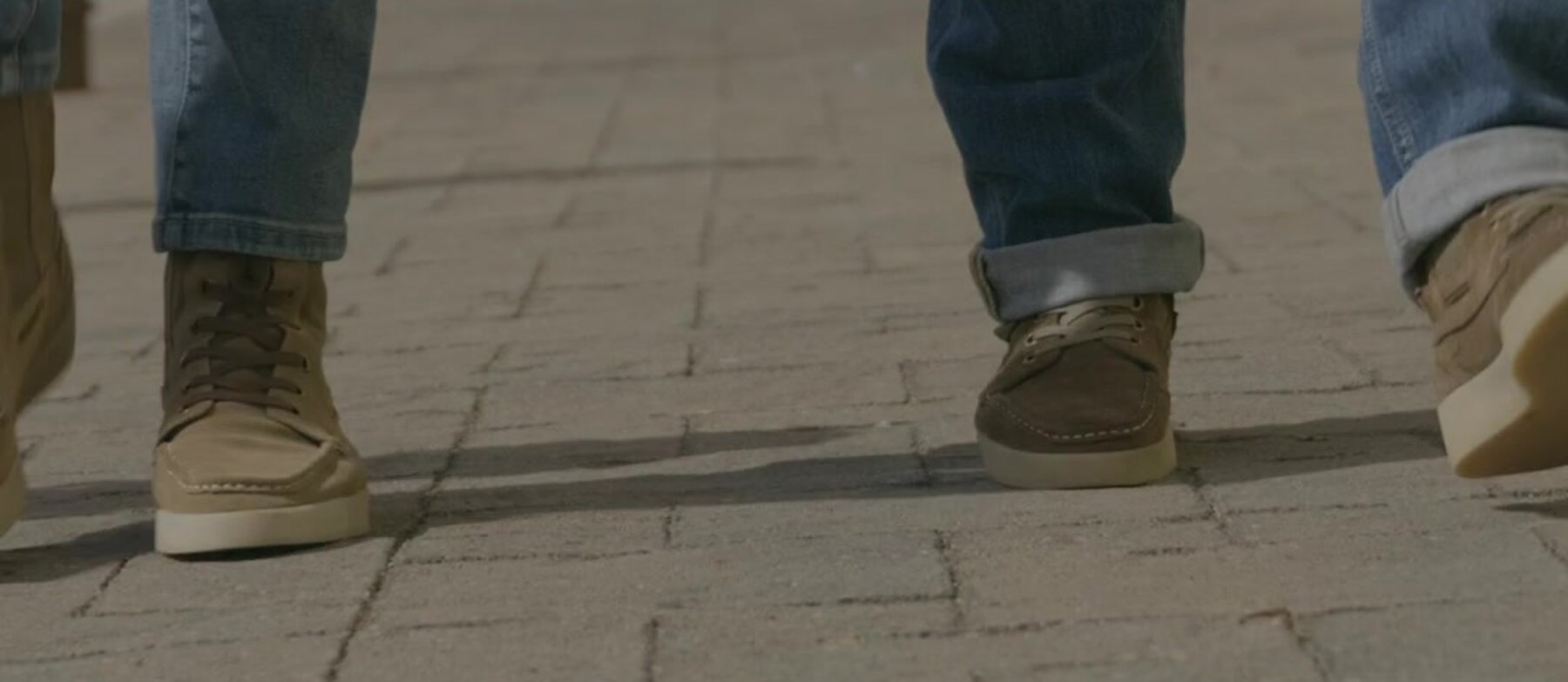 Two people walking in Park City Surfer boots on a paved street